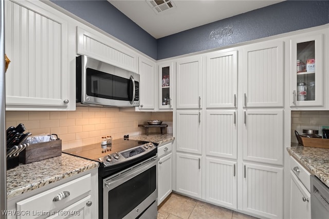 1450 Ulmer St, Greenwood, AR 72936 - kitchen with tasteful backsplash, white cabinets, appliances with stainless steel finishes, light stone countertops, and visible vents