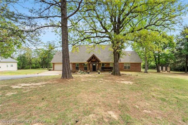 1450 Ulmer St, Greenwood, AR 72936 - view of front of home featuring a front lawn, driveway, brick siding, and a garage