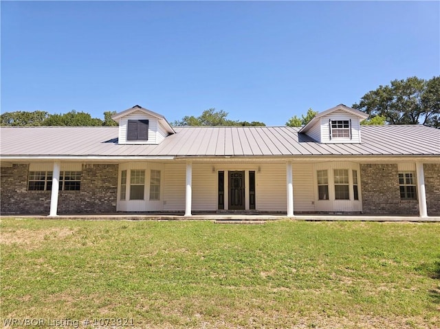 rear view of house with a lawn and a porch