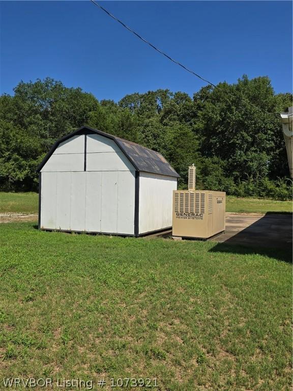 view of outdoor structure featuring a lawn