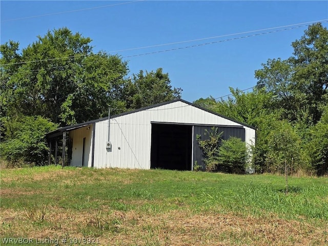 view of outbuilding featuring a yard
