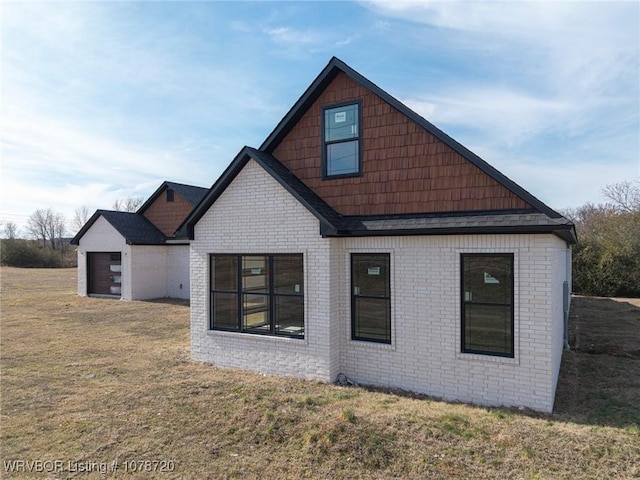 back of house with a lawn