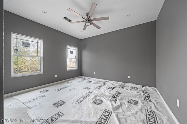 carpeted empty room featuring ceiling fan