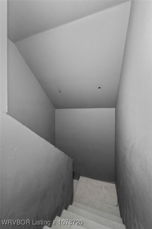 stairs featuring lofted ceiling