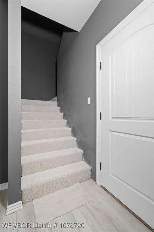 stairway with hardwood / wood-style flooring