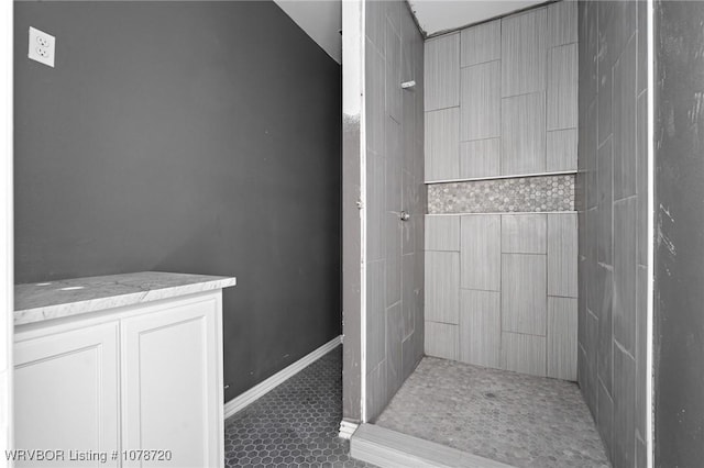 bathroom featuring a tile shower and tile patterned floors