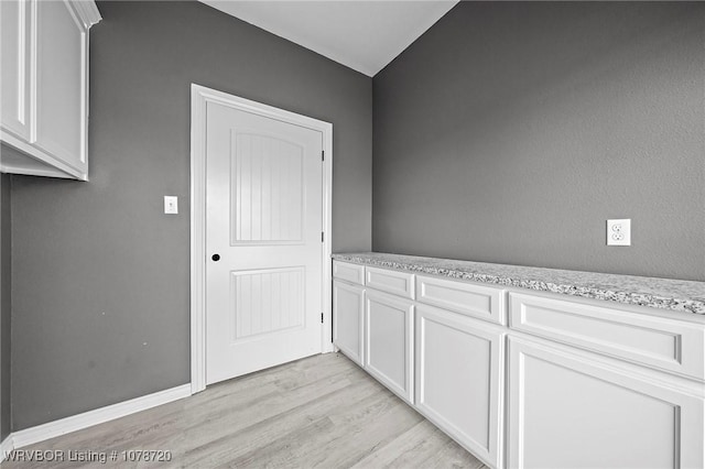 laundry room with light wood-type flooring