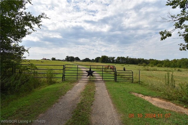 view of gate with a rural view