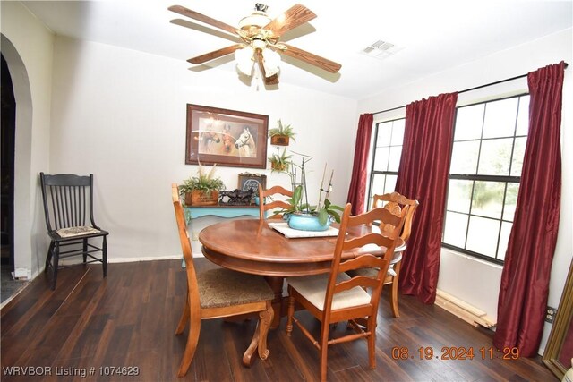 dining space with dark hardwood / wood-style flooring and ceiling fan