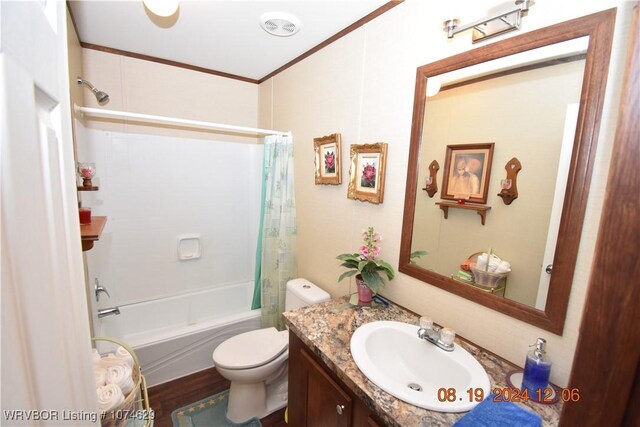 full bathroom with hardwood / wood-style floors, vanity, crown molding, toilet, and shower / bath combo with shower curtain