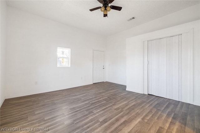 411 N Logan St, Charleston, AR 72933 - unfurnished bedroom featuring dark hardwood / wood-style flooring and ceiling fan