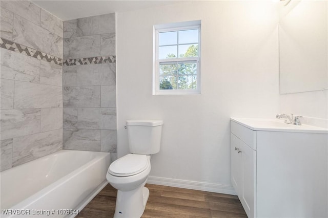 411 N Logan St, Charleston, AR 72933 - full bathroom featuring tiled shower / bath combo, vanity, hardwood / wood-style floors, and toilet