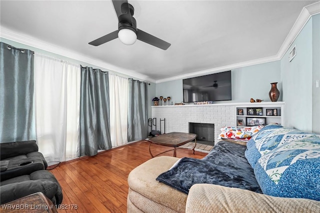 7 Bon Air St, Van Buren, AR 72956 - living room featuring crown molding, hardwood / wood-style floors, ceiling fan, a fireplace, and plenty of natural light