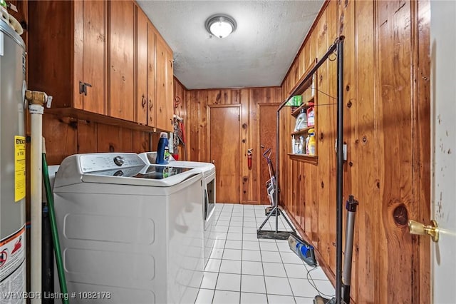 7 Bon Air St, Van Buren, AR 72956 - laundry room featuring independent washer and dryer, cabinet space, wood walls, light tile patterned flooring, and a textured ceiling