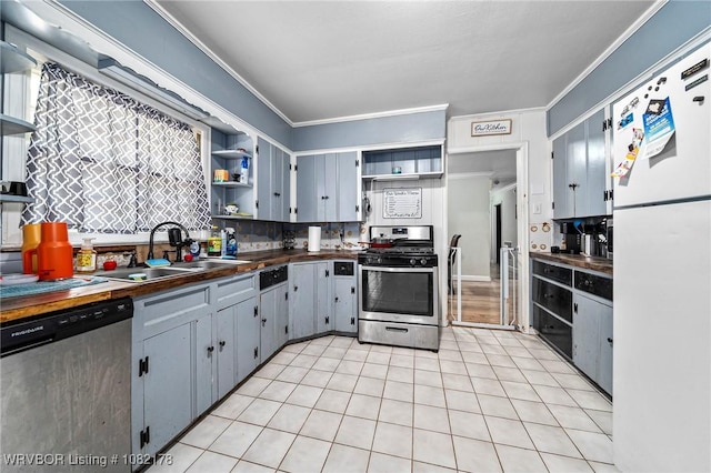 7 Bon Air St, Van Buren, AR 72956 - kitchen featuring open shelves, stainless steel appliances, light tile patterned floors, ornamental molding, and backsplash