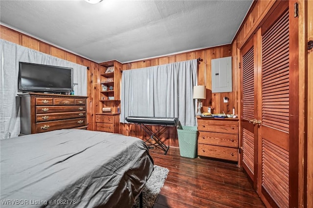 7 Bon Air St, Van Buren, AR 72956 - bedroom featuring electric panel, wooden walls, dark wood-type flooring, and a closet