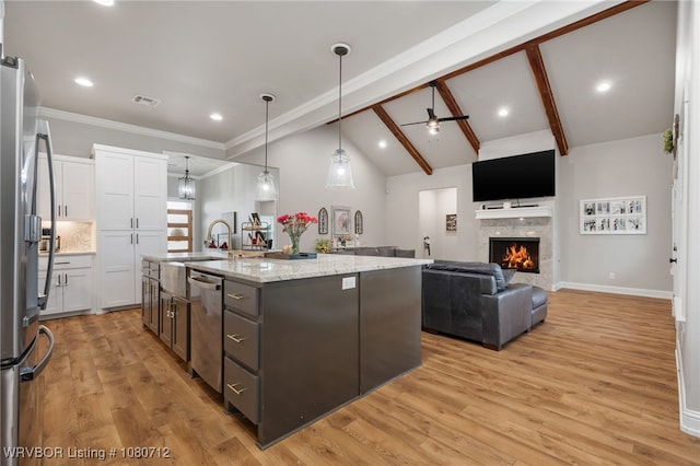4100 Margate Dr, Fort Smith, AR 72903 - kitchen featuring appliances with stainless steel finishes, ceiling fan, lofted ceiling with beams, and white cabinets