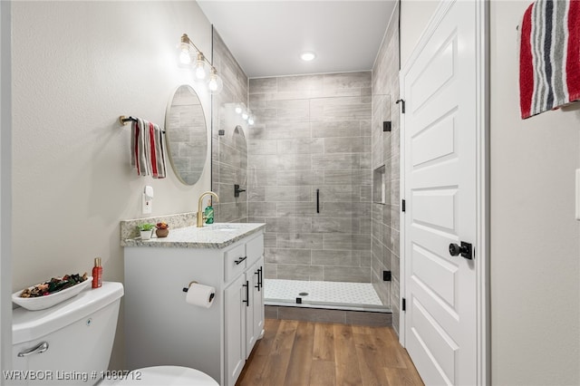 4100 Margate Dr, Fort Smith, AR 72903 - bathroom featuring a stall shower, wood finished floors, vanity, toilet, and recessed lighting