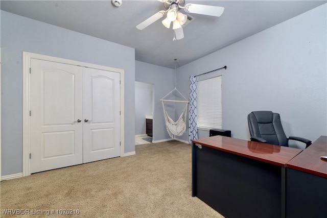 carpeted office featuring ceiling fan