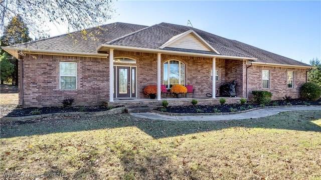 single story home featuring a front yard and covered porch