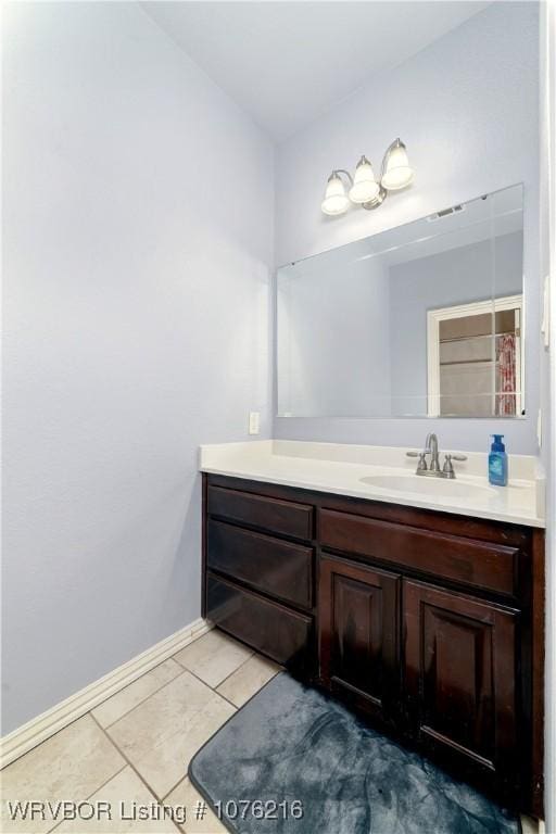 bathroom with tile patterned flooring and vanity