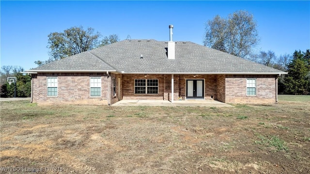 back of property featuring a patio area and a yard