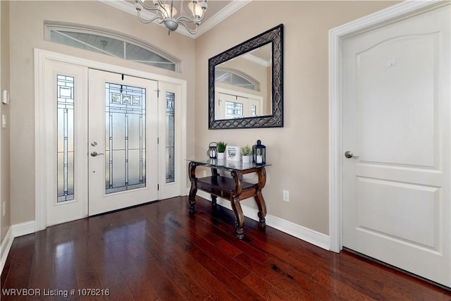 entryway with a notable chandelier, crown molding, and dark wood-type flooring