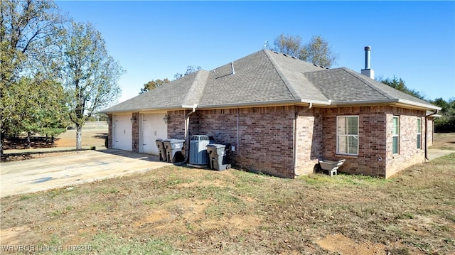 view of home's exterior with a yard and a garage