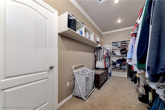 walk in closet featuring light carpet