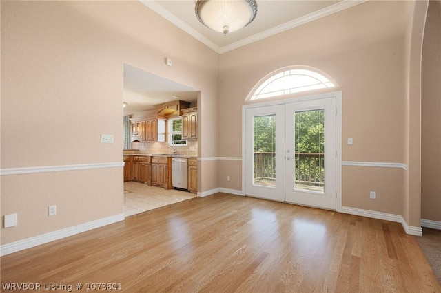 interior space featuring french doors, light hardwood / wood-style floors, and ornamental molding