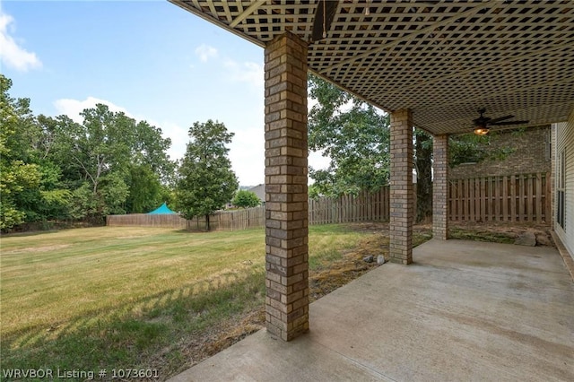 view of yard with ceiling fan and a patio