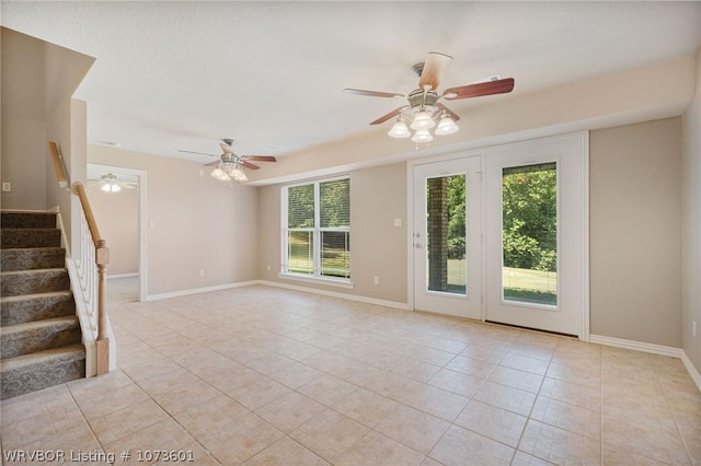 spare room featuring light tile patterned floors and ceiling fan