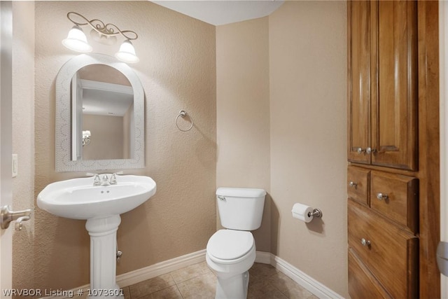 bathroom with tile patterned flooring and toilet