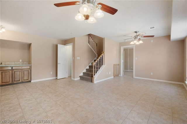 unfurnished living room with ceiling fan