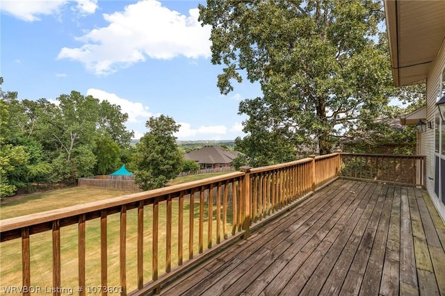 wooden deck with a lawn