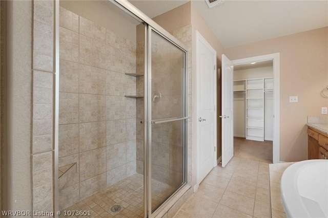 bathroom featuring tile patterned flooring, vanity, and independent shower and bath