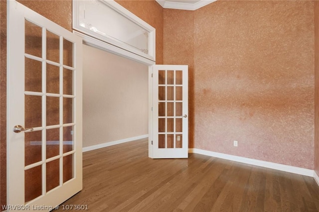 spare room with hardwood / wood-style floors and french doors