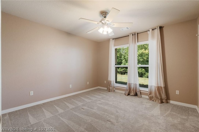 carpeted empty room with ceiling fan