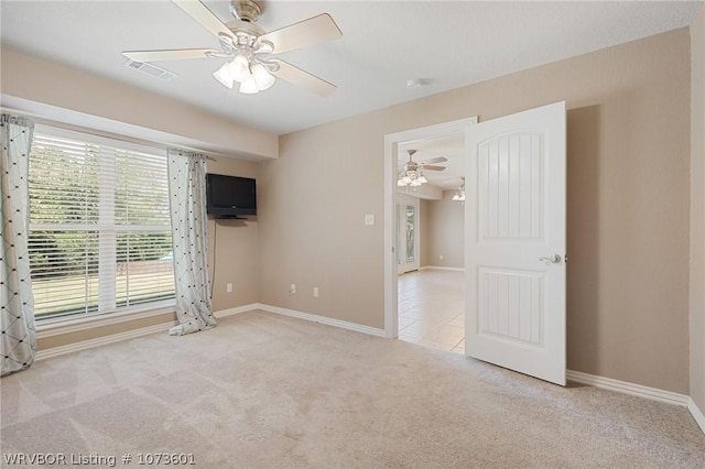 interior space featuring ceiling fan and light colored carpet