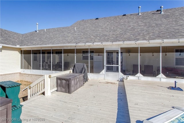 deck featuring a sunroom and a grill