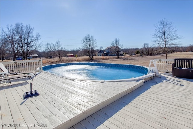 view of swimming pool with a wooden deck