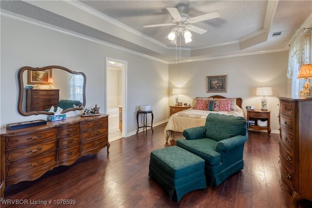 bedroom with crown molding, ceiling fan, a tray ceiling, and a textured ceiling