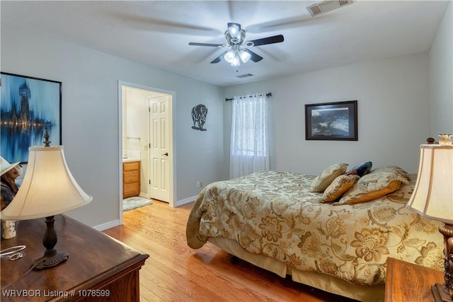 bedroom with ceiling fan, ensuite bathroom, and light hardwood / wood-style floors