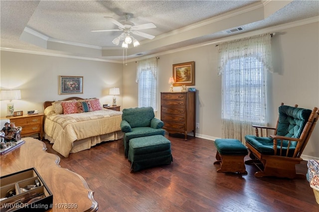 bedroom featuring ceiling fan, a raised ceiling, crown molding, dark wood-type flooring, and a textured ceiling