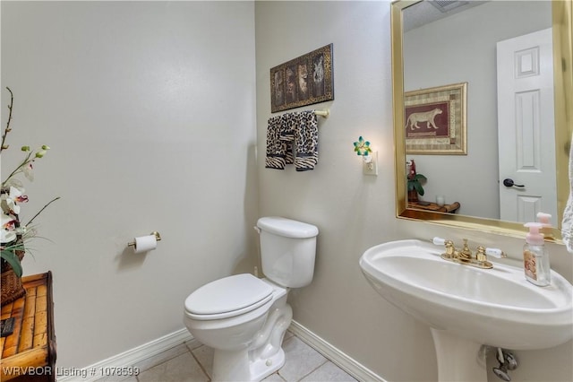 bathroom with tile patterned flooring, sink, and toilet