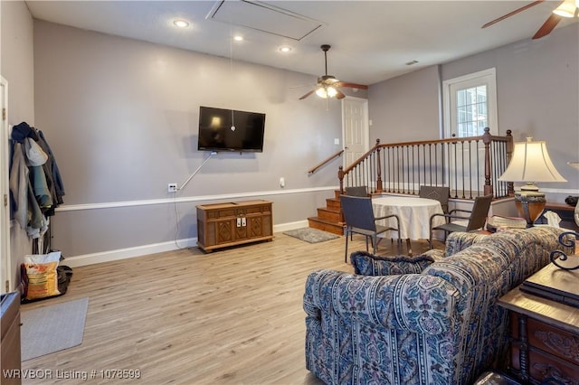 living room with ceiling fan and light wood-type flooring