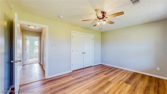 6562 Broadleaf Dr, Alma, AR 72921 - unfurnished bedroom with light wood-type flooring, a closet, and ceiling fan