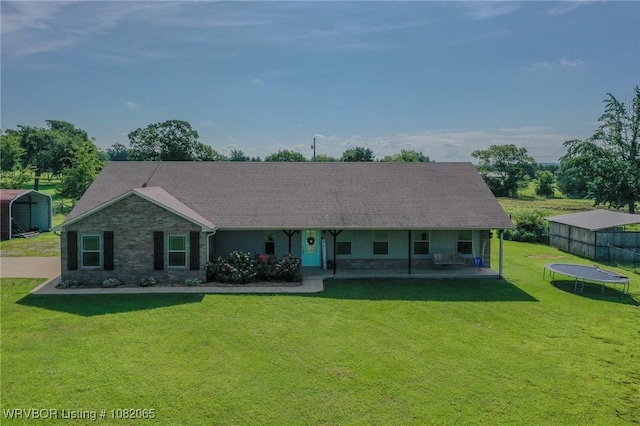 6562 Broadleaf Dr, Alma, AR 72921 - view of front of property featuring a trampoline, a front lawn, covered porch, and a carport