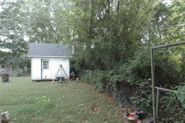 view of outdoor structure featuring a lawn