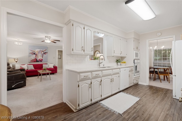 6410 Ellsworth Rd, Fort Smith, AR 72903 - kitchen with white appliances, a sink, a chandelier, white cabinets, and light countertops